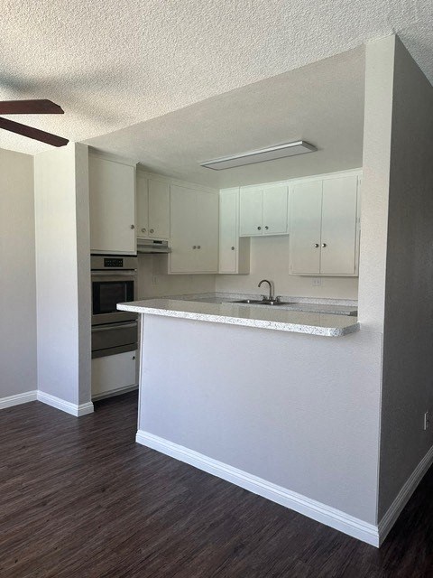 A kitchen with white cabinets and a countertop.